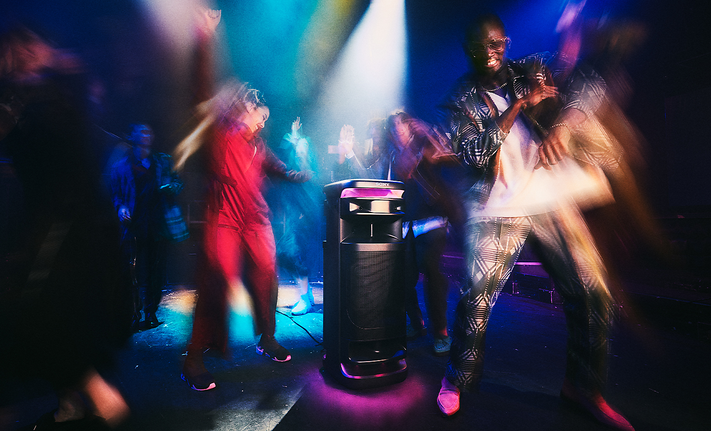 Des gens dansent dans une boîte de nuit avec l'enceinte ULT TOWER 10 qui diffuse la musique.