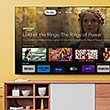 A living room with a wall-mounted BRAVIA TV displaying an array of entertainment apps and streaming services